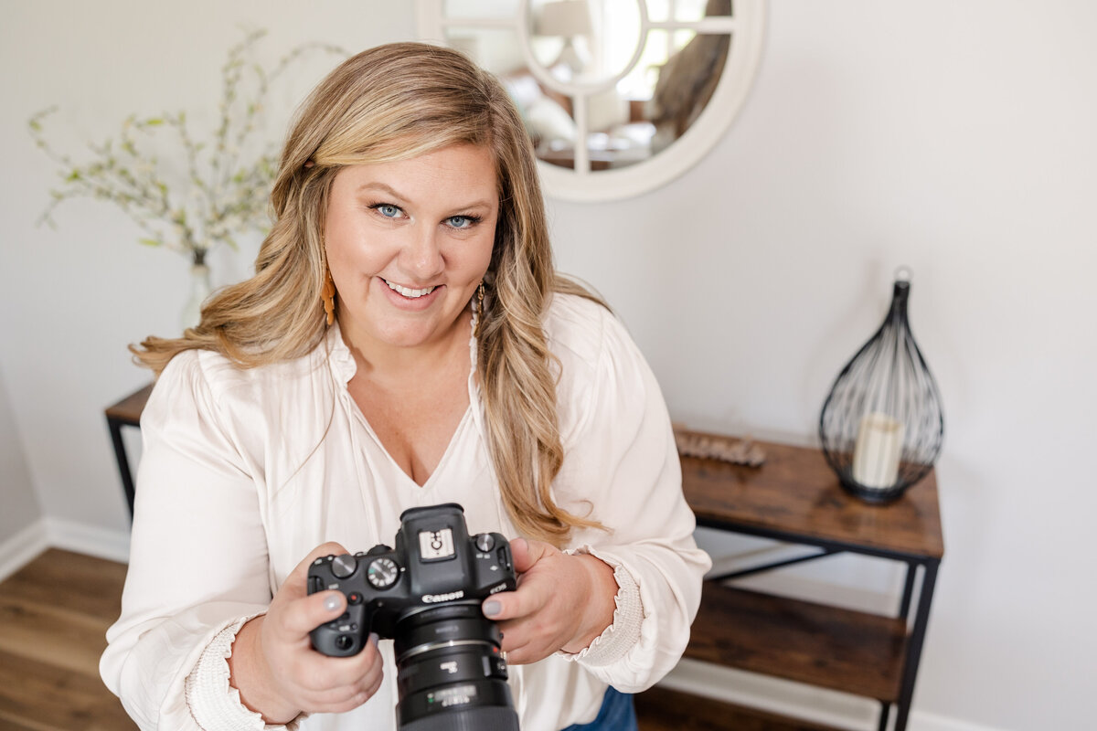 A behind-the-scenes shot of Meg Williamson capturing a living room with professional equipment, including a tripod, camera, and lighting setup. The image highlights her attention to detail and commitment to producing high-quality real estate photography.