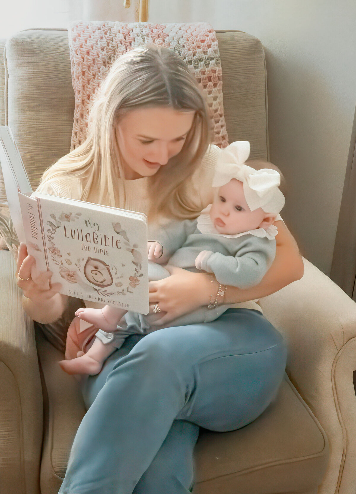 in home lifestyle session with newborn mom reading in nursery