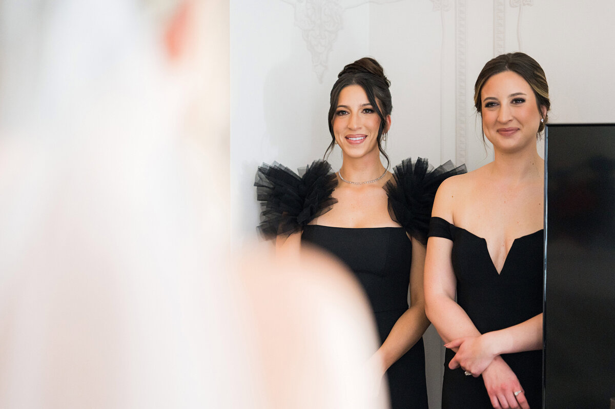 bride sisters looking at her admiring