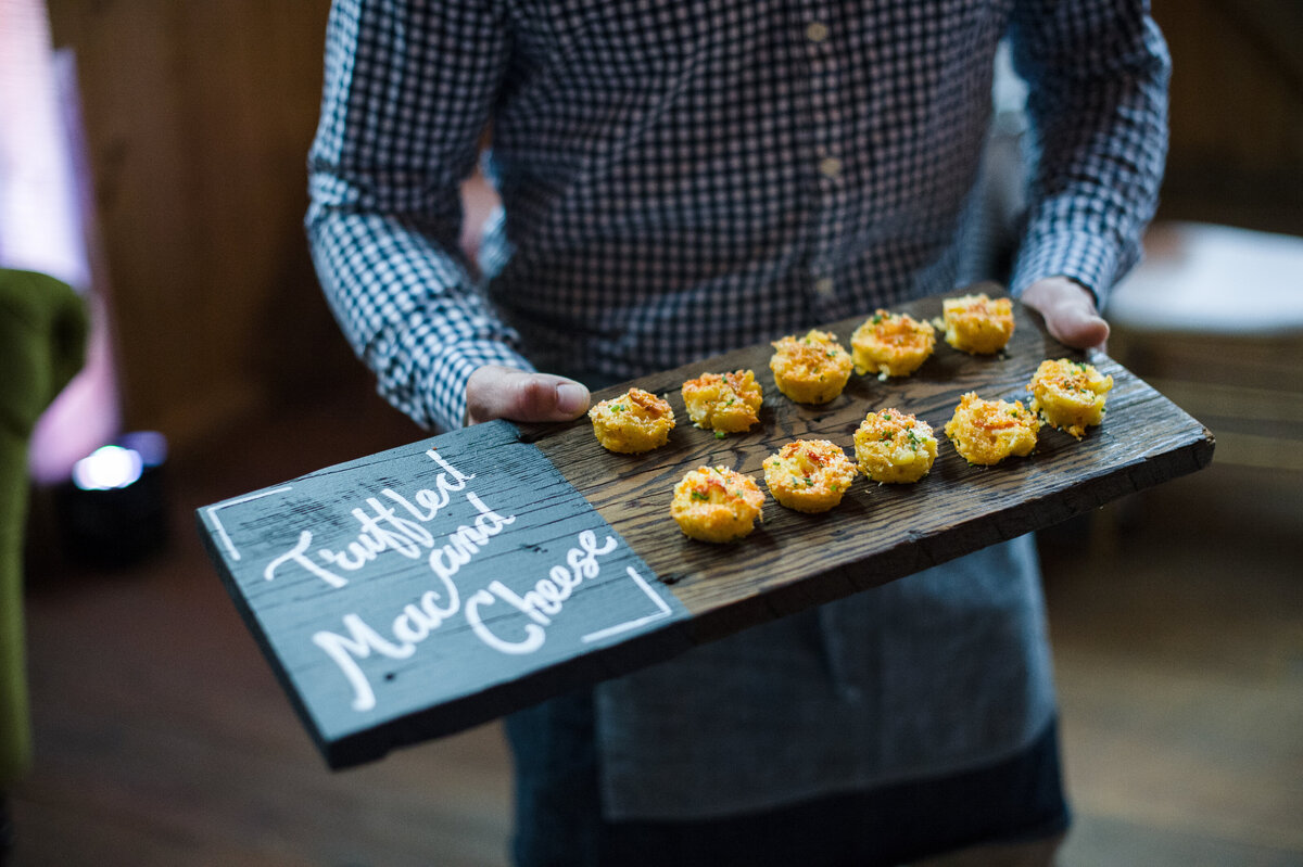 truffled macaroni and cheese bites at Willowbrook wedding venue served by a service attendant