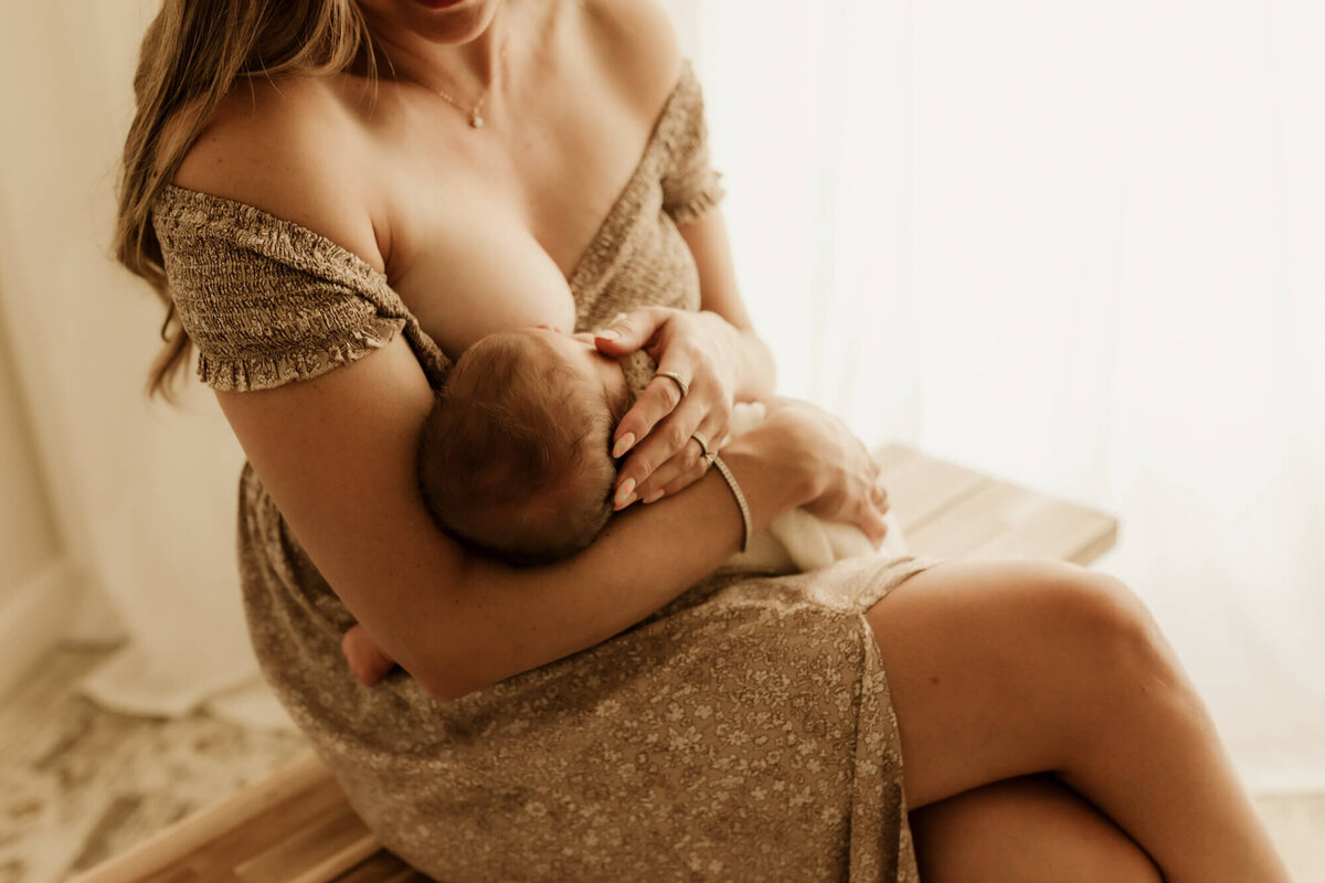 Mother breastfeeds her newborn daughter in OKC.