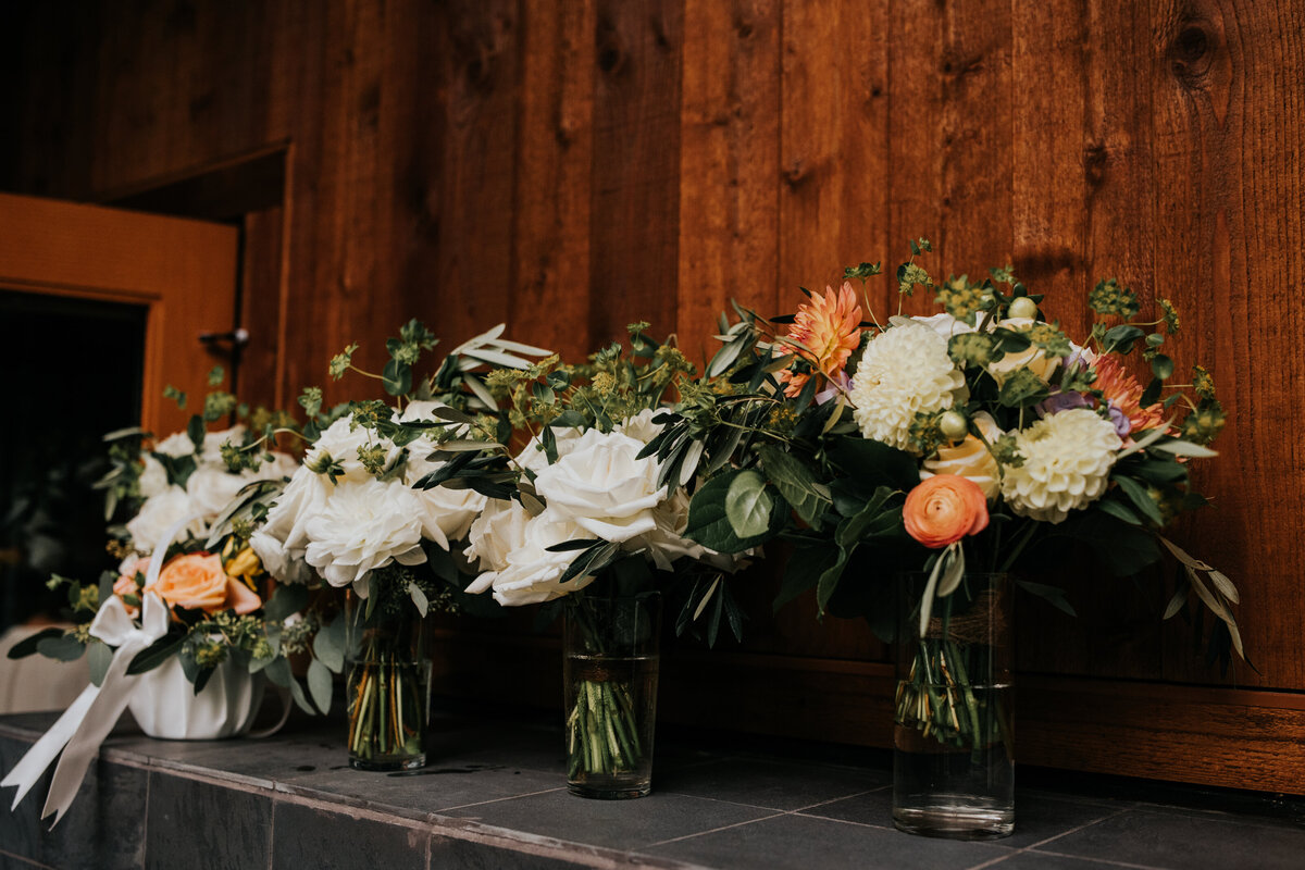 Bridesmaids bouquet mad of peach, coral and white flowers.