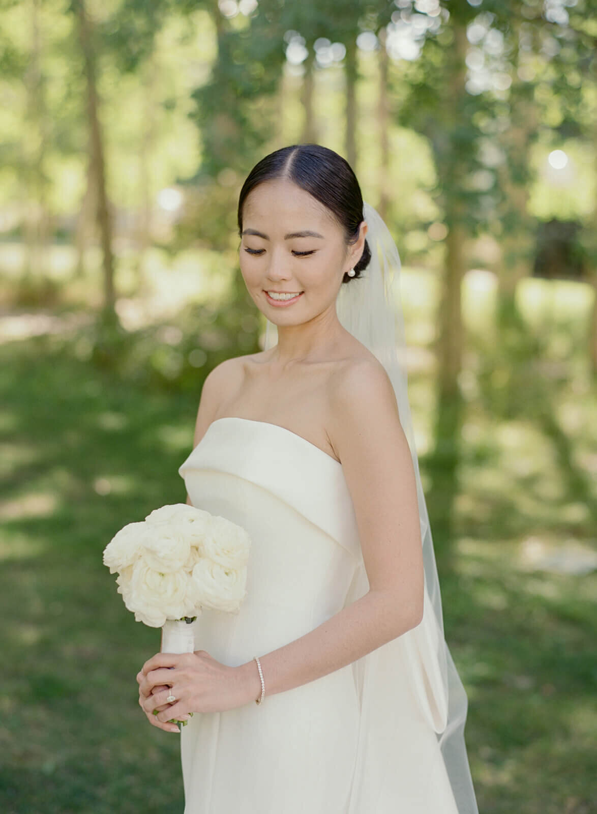 Bride poses gracefully, surrounded by the vibrant scenery of her Aspen Meadows Resort wedding.