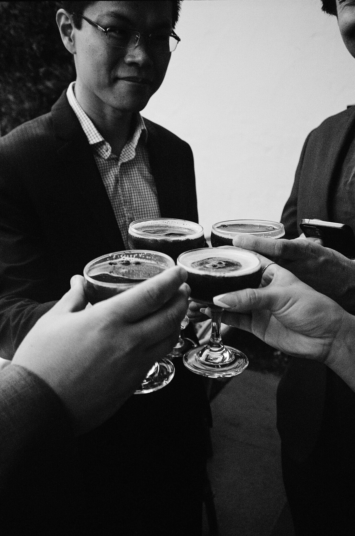 groomsmen holding drinks together
