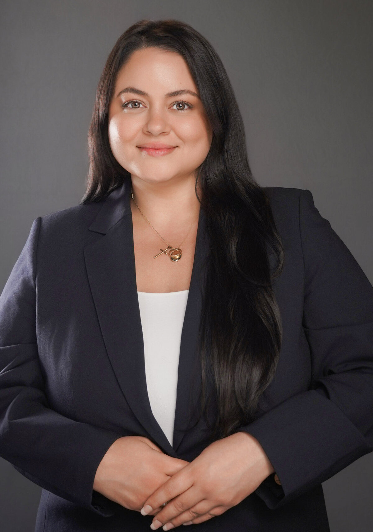 Professional headshot of a woman with long black hair in a navy blazer, captured by Lynda Louis Photography in Atlanta for corporate branding