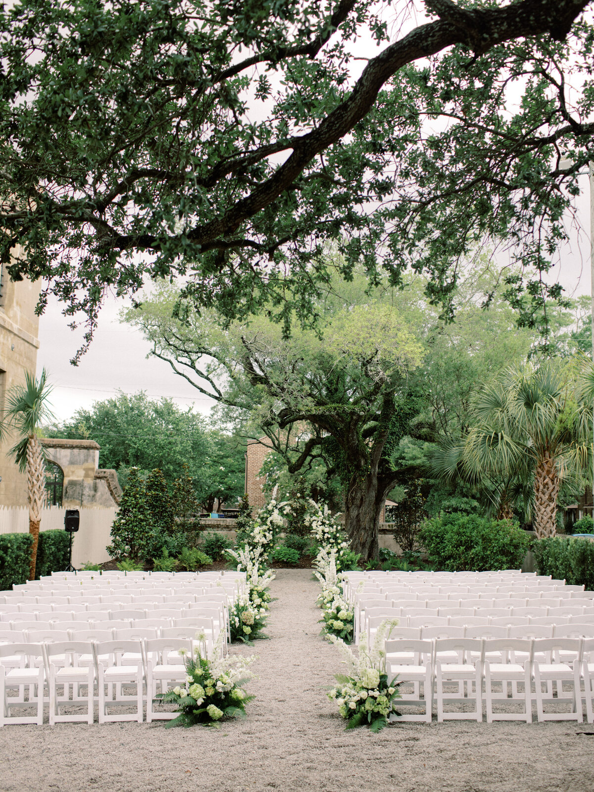 An enchanting outdoor wedding ceremony at Twenty-One Magazine in Charleston featuring beautifully arranged floral decorations, creating a romantic ambiance for a memorable celebration.
