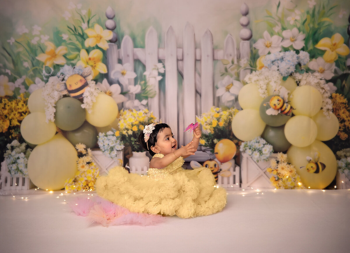Whimsical cake smash portrait with baby playing and laughing – Ottawa studio session