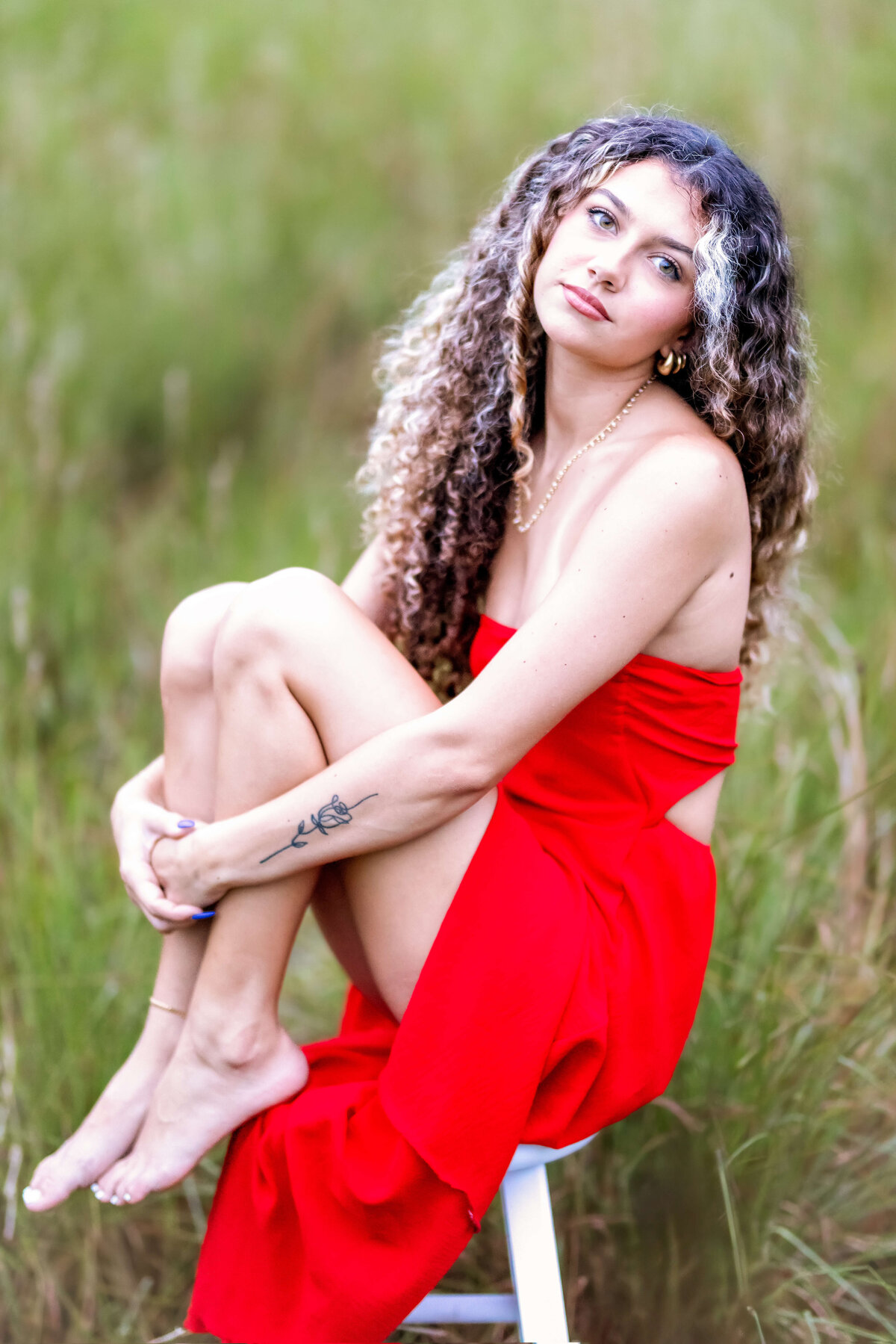 Orlando senior photographer captures a striking close-up of a teen girl in a red dress.