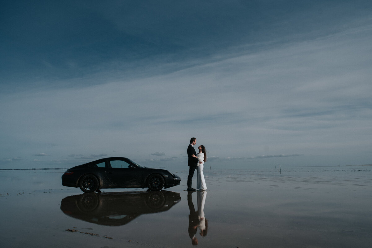 couple with car on beach