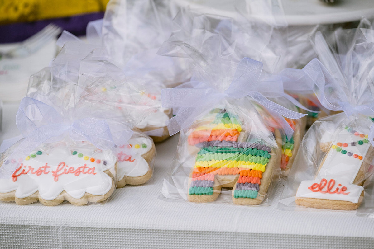 Fiesta-themed cookie treats shaped like piñatas displayed on a colorful dessert table at a Bay Area first birthday party, photographed in Novato.