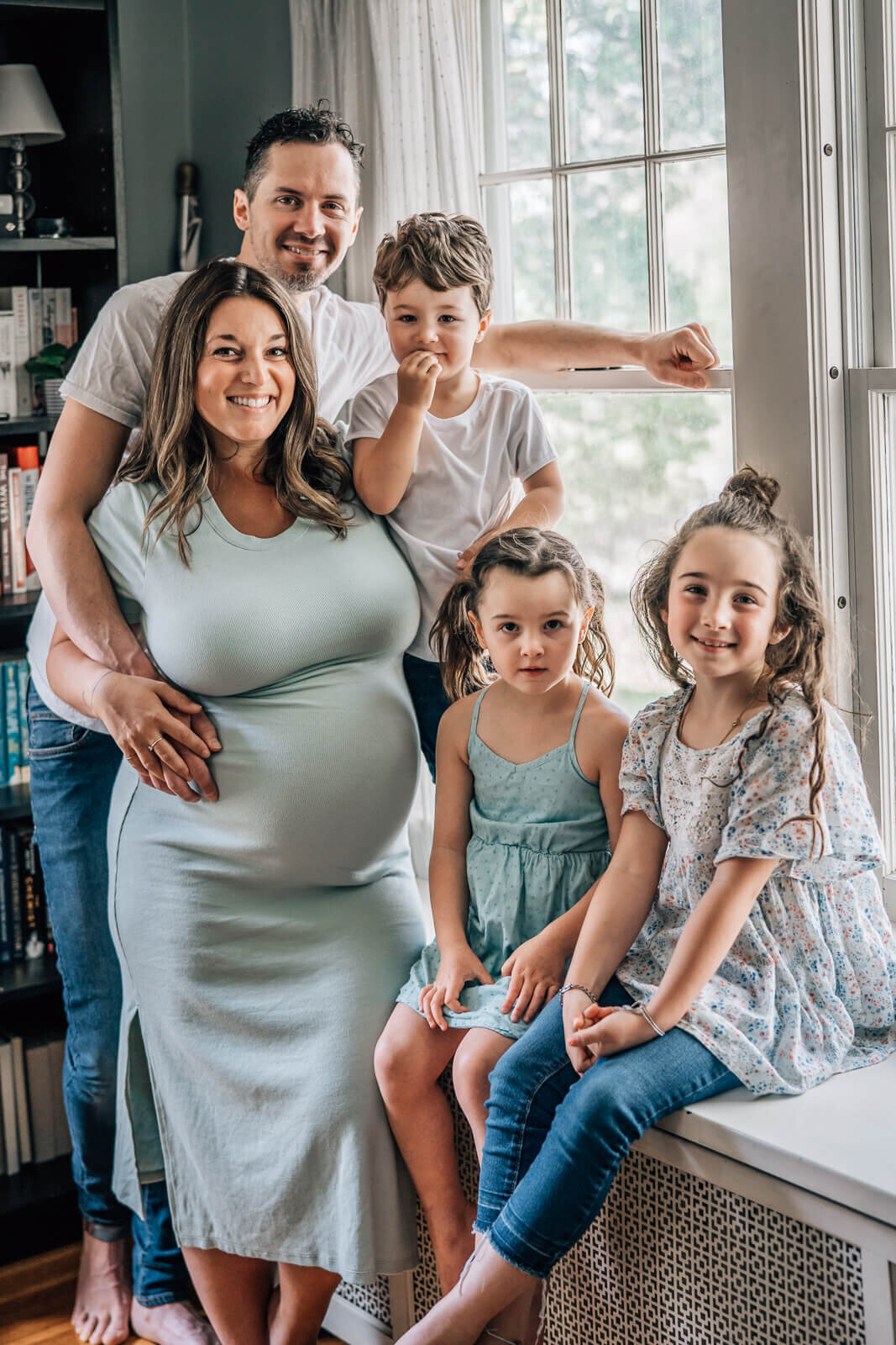 A lifestyle portrait of a large family, soon expecting another child, during a maternity session by Minneapolis lifestyle photographer, Kate Simpson.