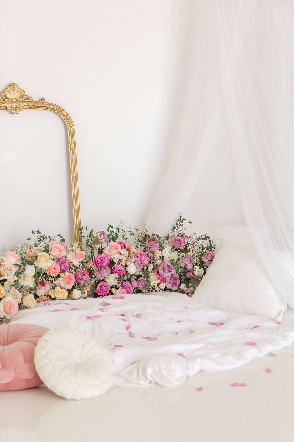 roses in peach, blush and pink with throw blankets, pillows and a gold mirror