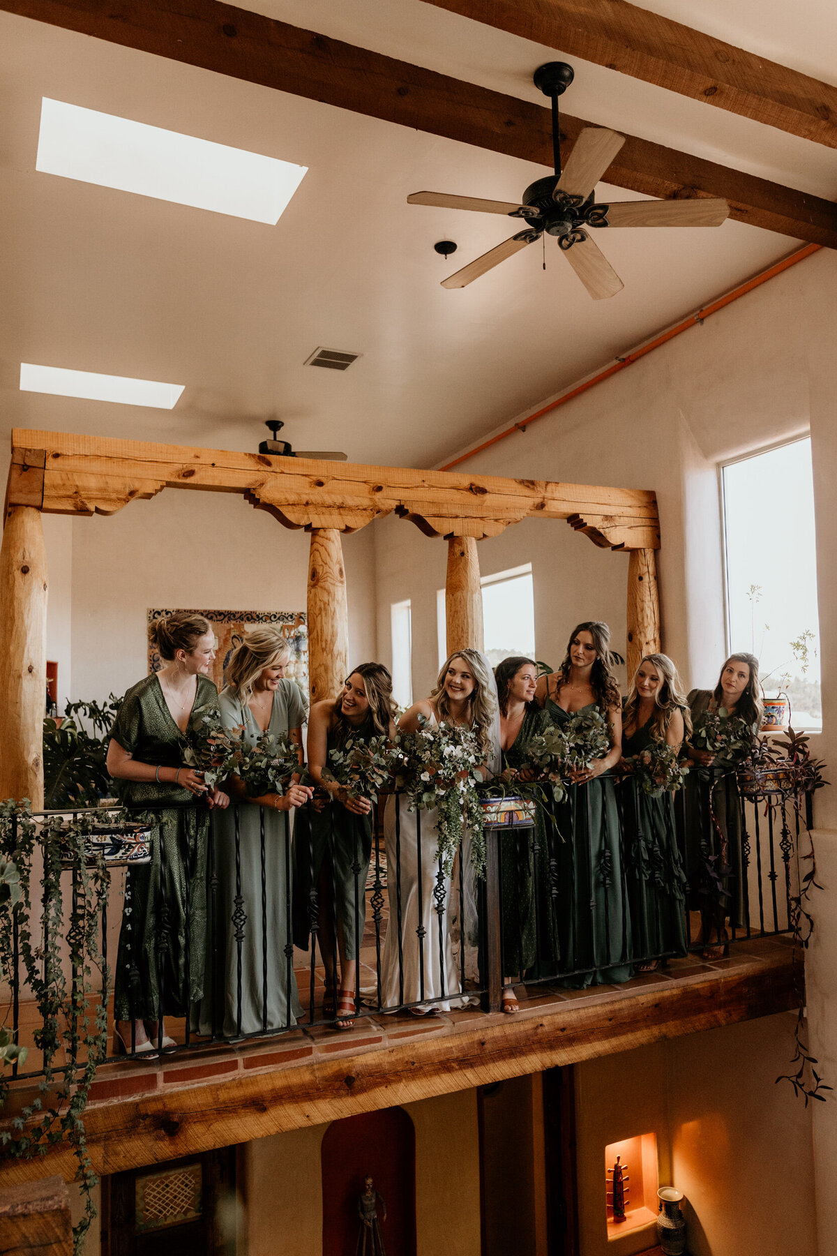 bride and her bridesmaids on a balcony
