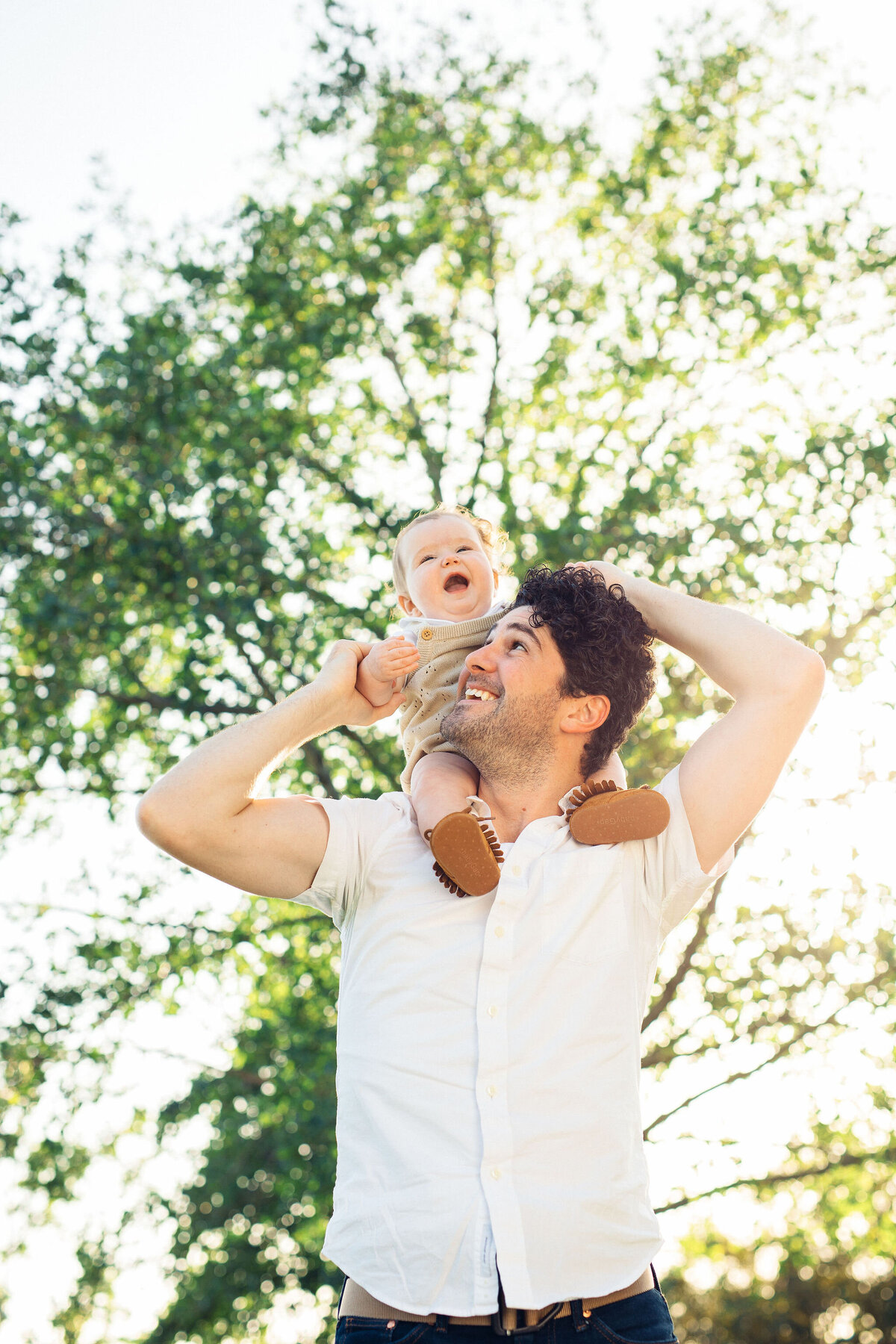 Family Portrait Photo Of Baby Laughing While Riding Her Father's Shoulder Los Angeles