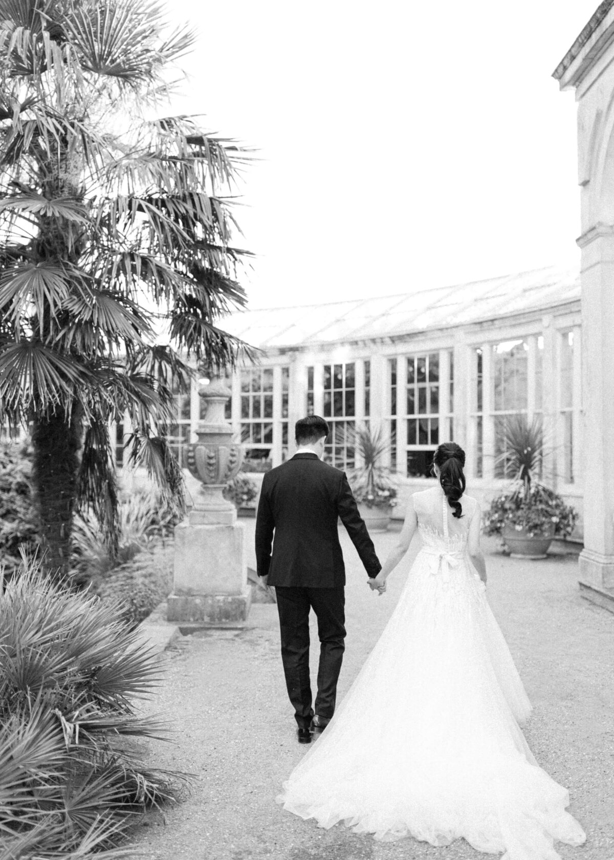 chloe-winstanley-weddings-syon-park-elie-saab-couple-walking-conservatory