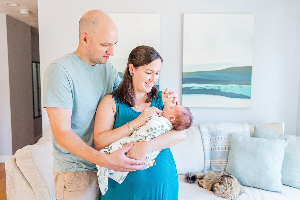parents smile at baby  during in home newborn photo session with Sara Sniderman Photography in Metro West Boston Massachusetts
