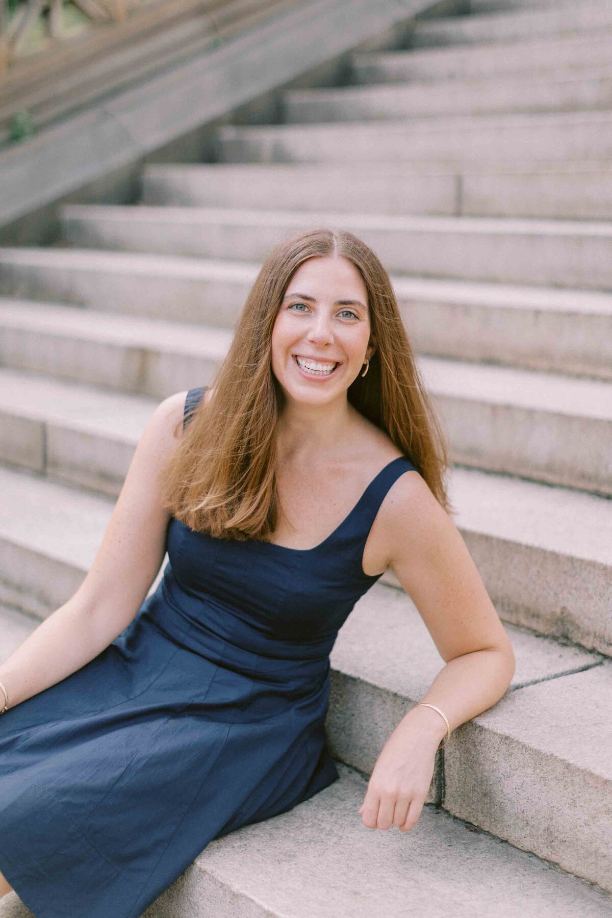 Woman leaning back on stairs and smiling