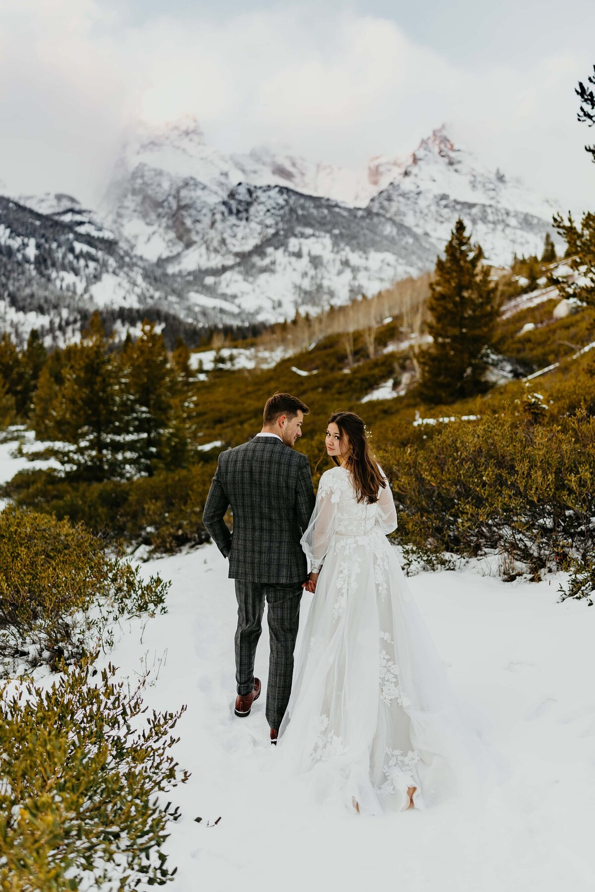 A couple doing their bridal photos on Taggart Lake Trail in Grand Teton National Park