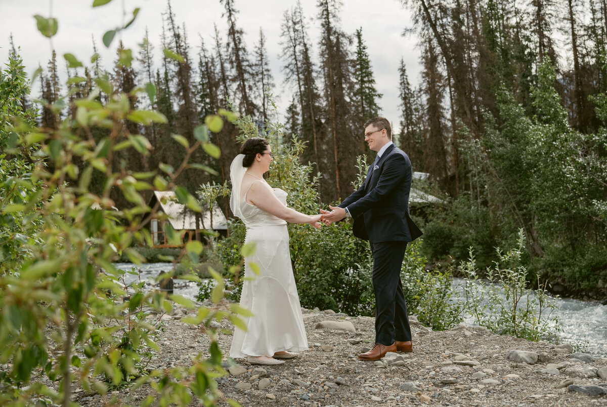 A couple has their first look at their  elopement in the mountains in Alaska