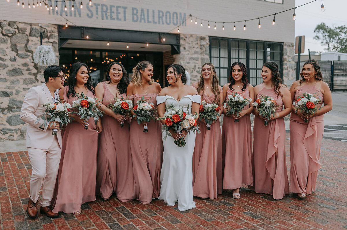 Bride and bridesmaids holding their bouquets outside of the venue