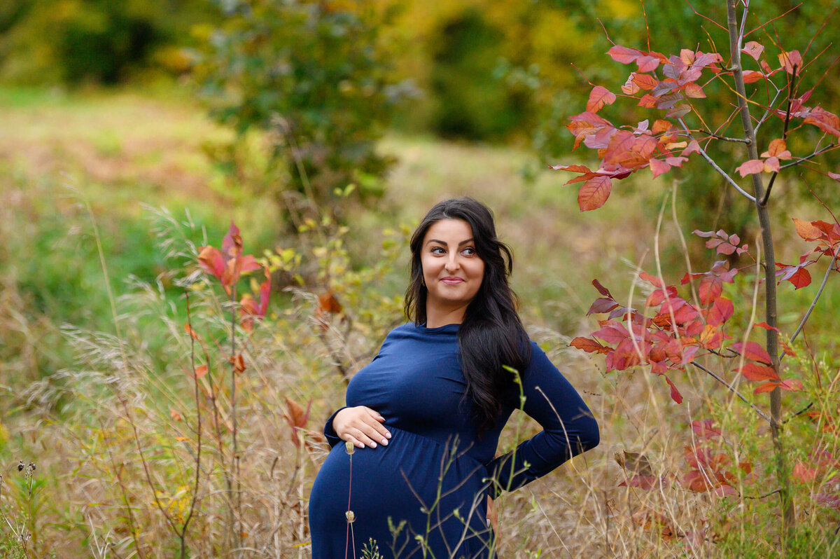 maternity photography session outdoors in the fall with a brown-haired pregnant woman in Burlington, On