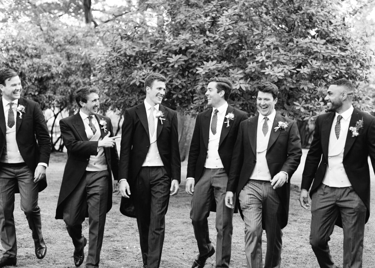 chloe-winstanley-weddings-ushers-group-walking-black-white