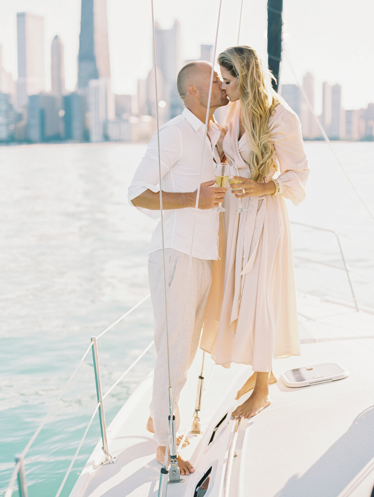 Bride and groom kissing on boat photographed by Chicago editorial wedding photographer Arielle Peters