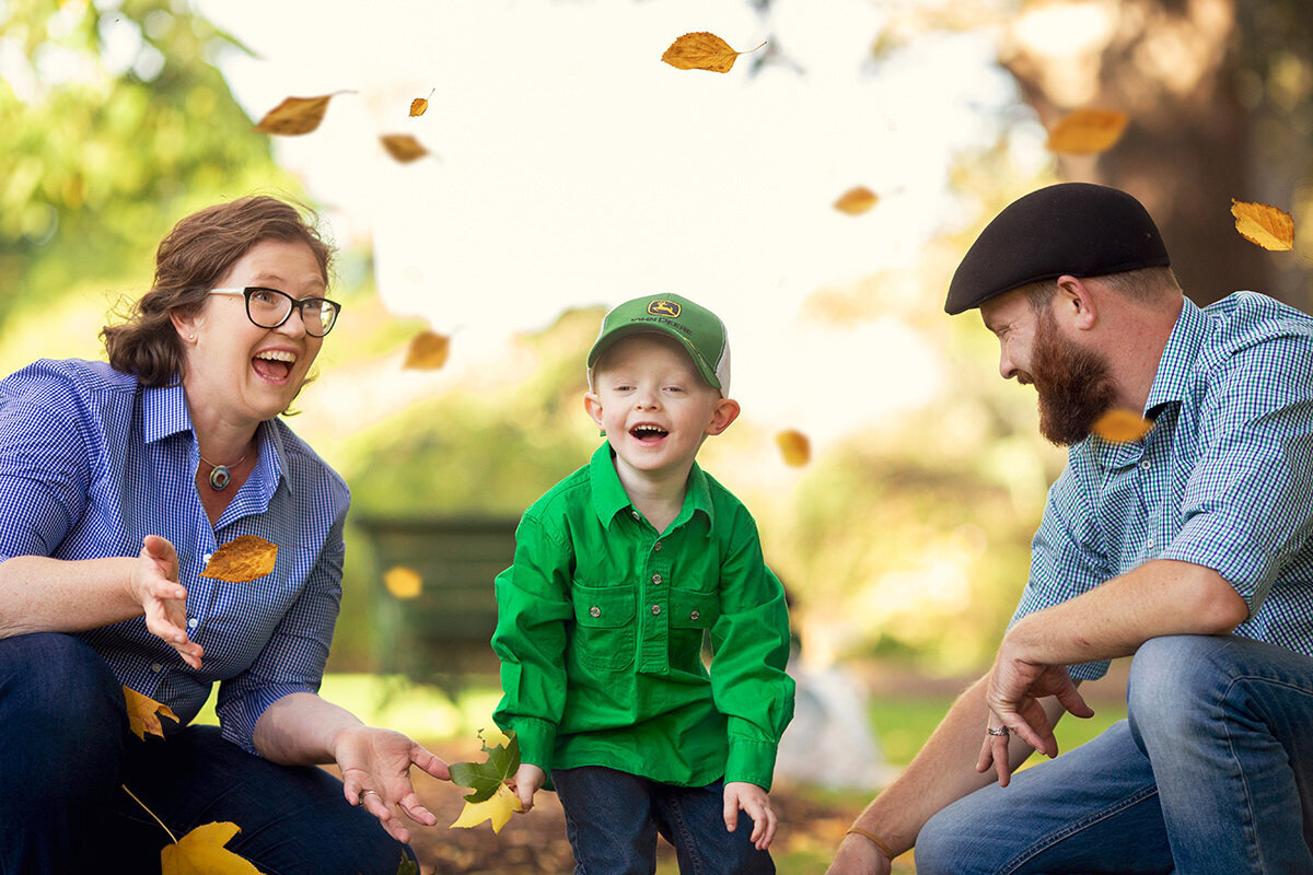 family-playing-in-autumn-leaves