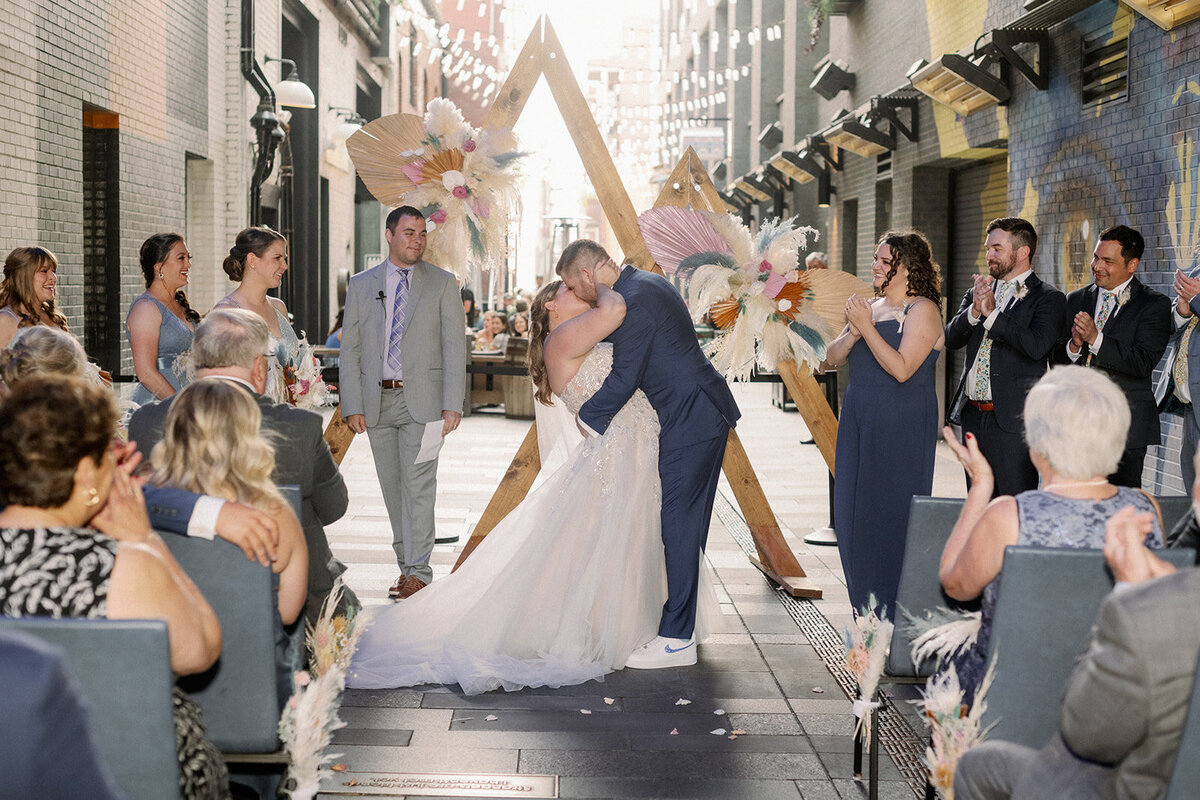Bride and groom share their first kiss during their city wedding ceremony in Denver Colorado.