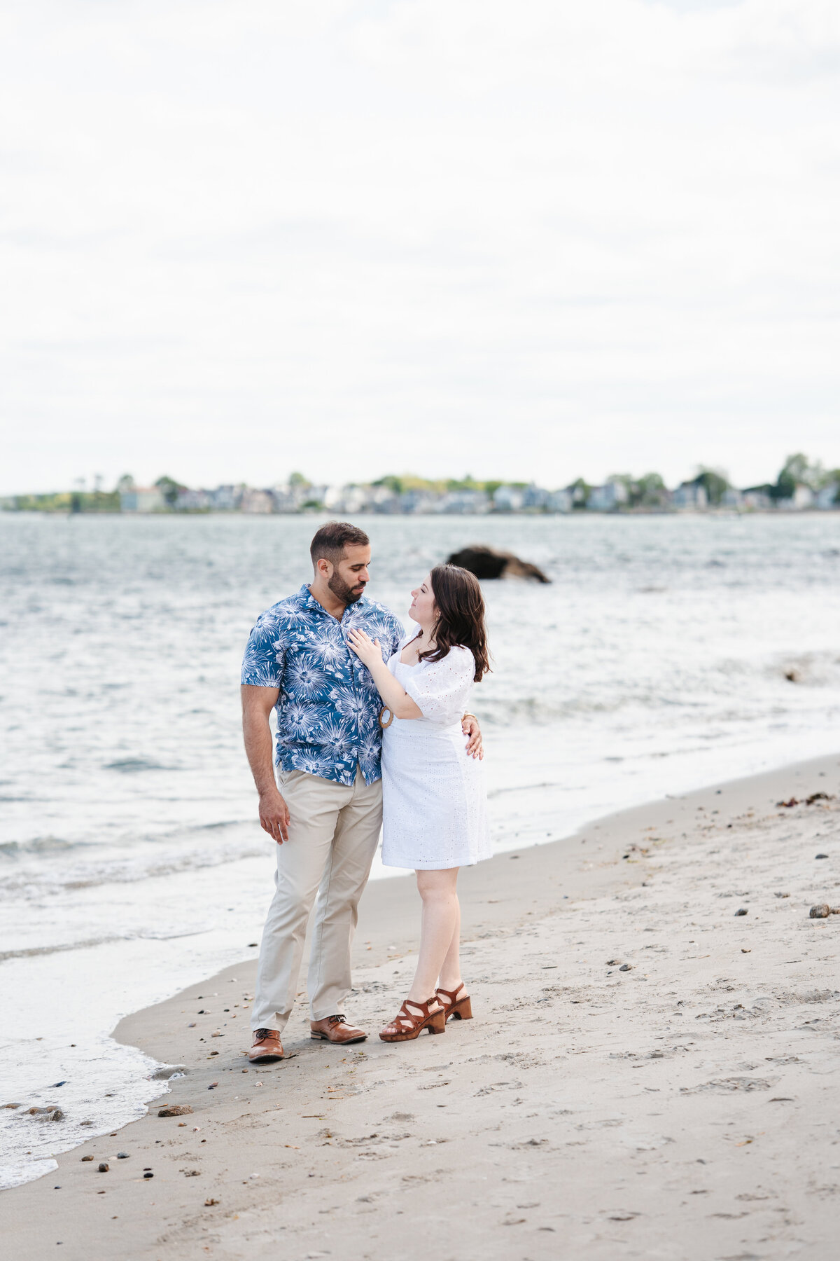 Couple walking through the rose garden at Lynch Park during their Beverly engagement session with Danielle Littles Photography