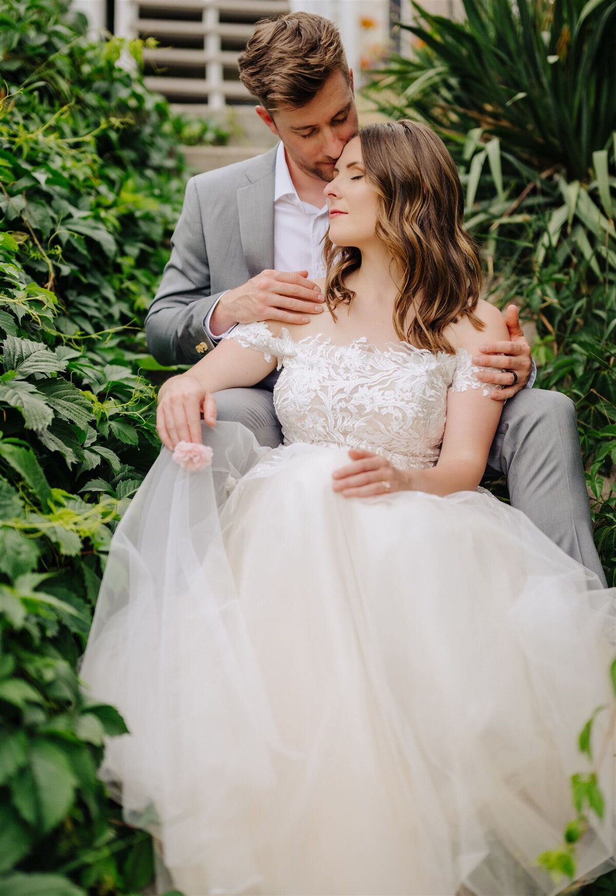 a couple sitting lovingly taking a moment during their wedding