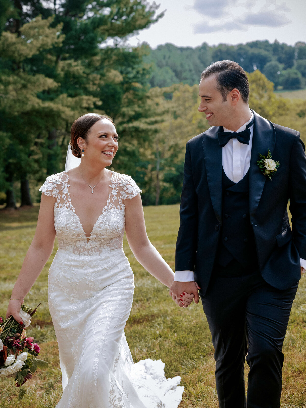 cheerful-bride-and-groom-walking-in-nature
