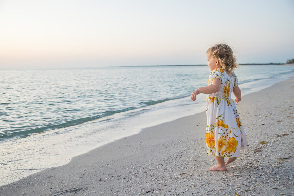 A toddler staring at the ocean