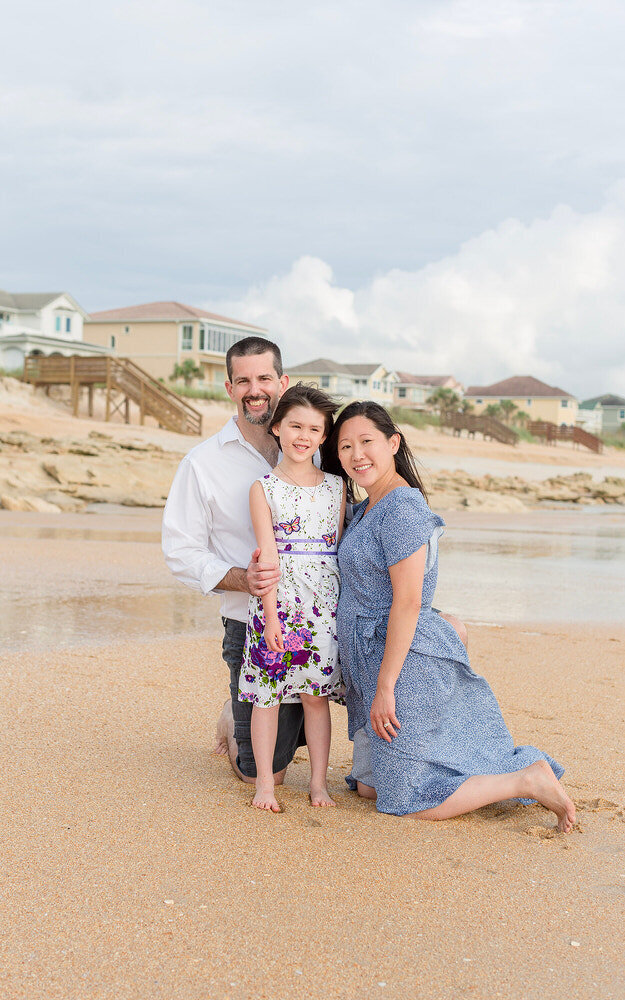 Beach family in St Augustine beach smiling, mom, dad an daughter