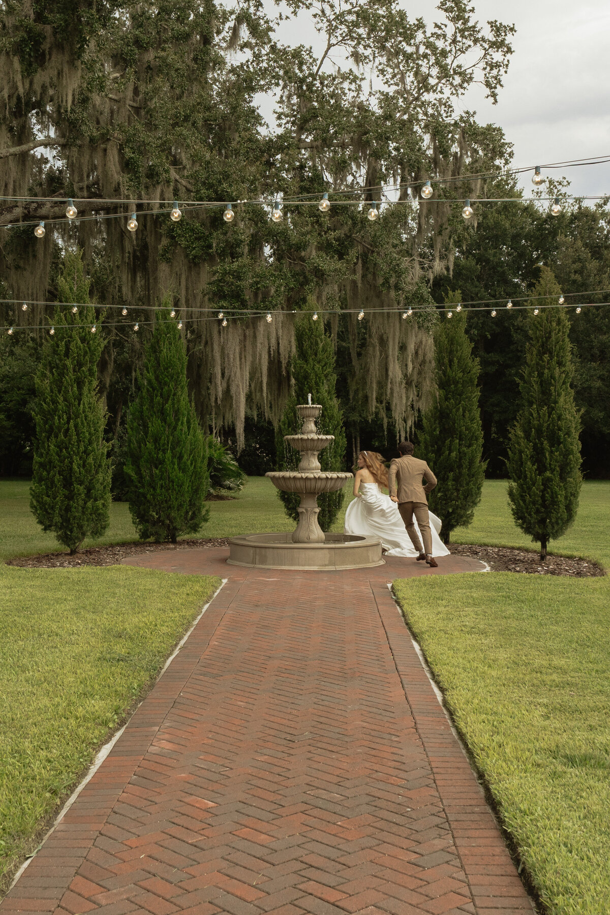 Romantic backyard wedding at The Palm Mansion in Umatilla, Florida with lush palm trees and floral arch
