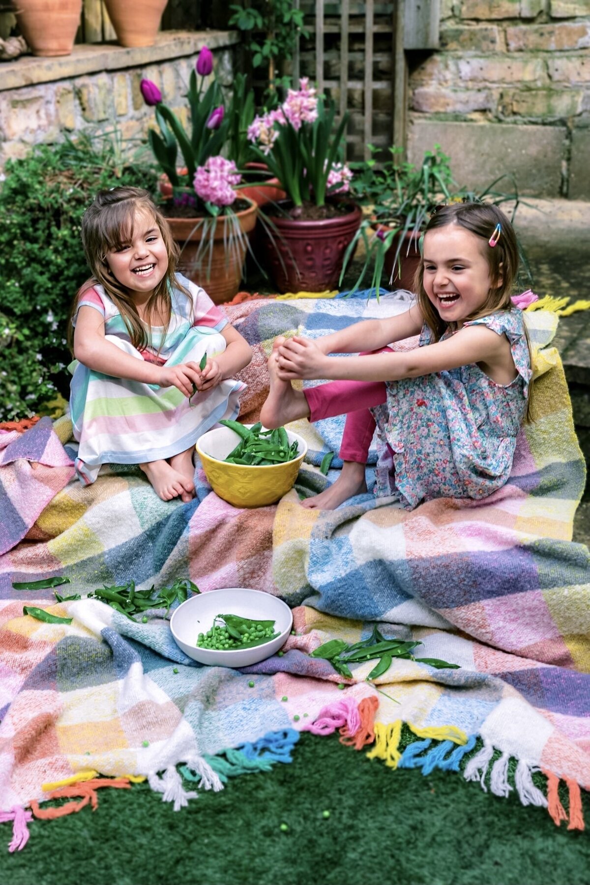 children poding peas in the garden