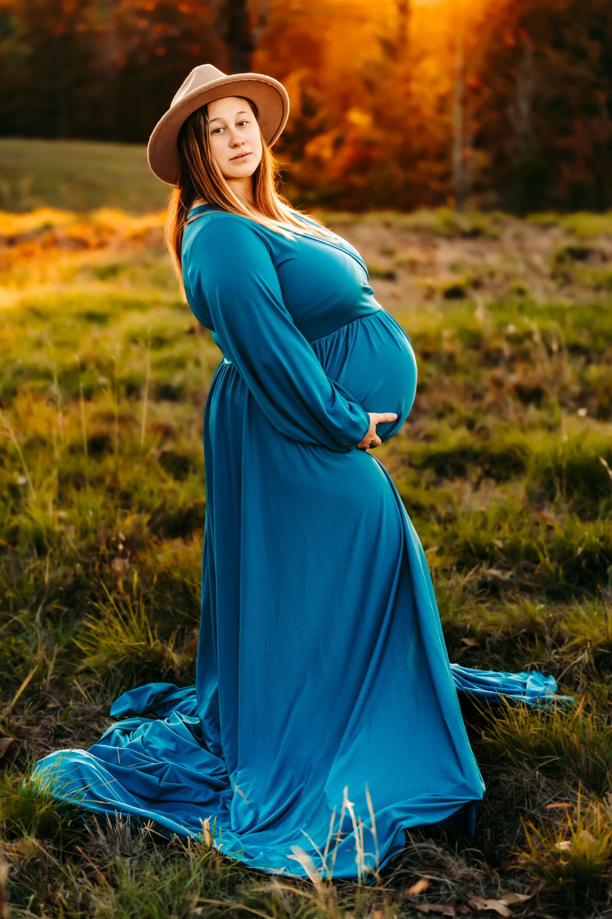maternity portrait of pregnant woman in a blue dress