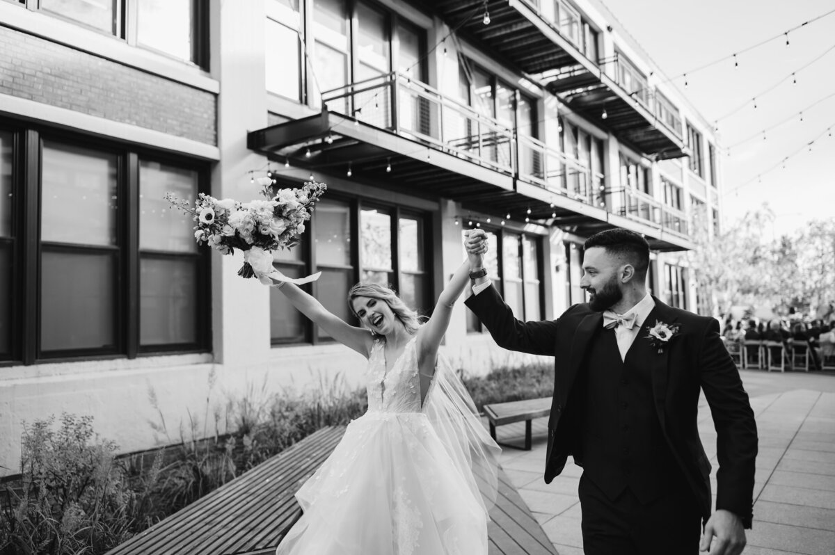 Bride and groom celebrate with emotion at their Greenhouse Loft Wedding