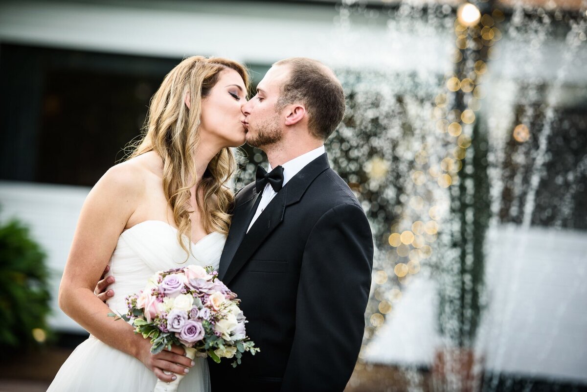 Bride and groom kiss during portraits at Southern Oaks wedding