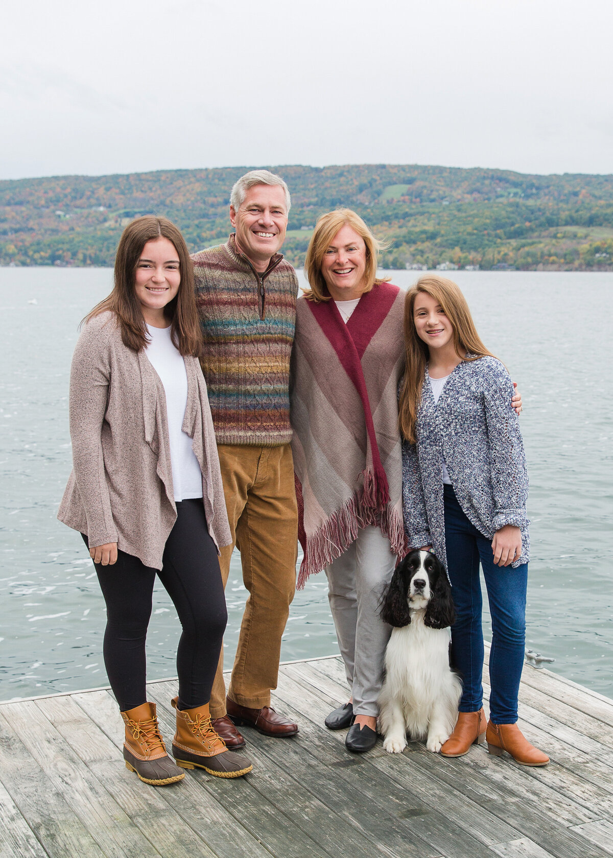 Family photos on Canandaigua Lake with two daughters and dog in the fall