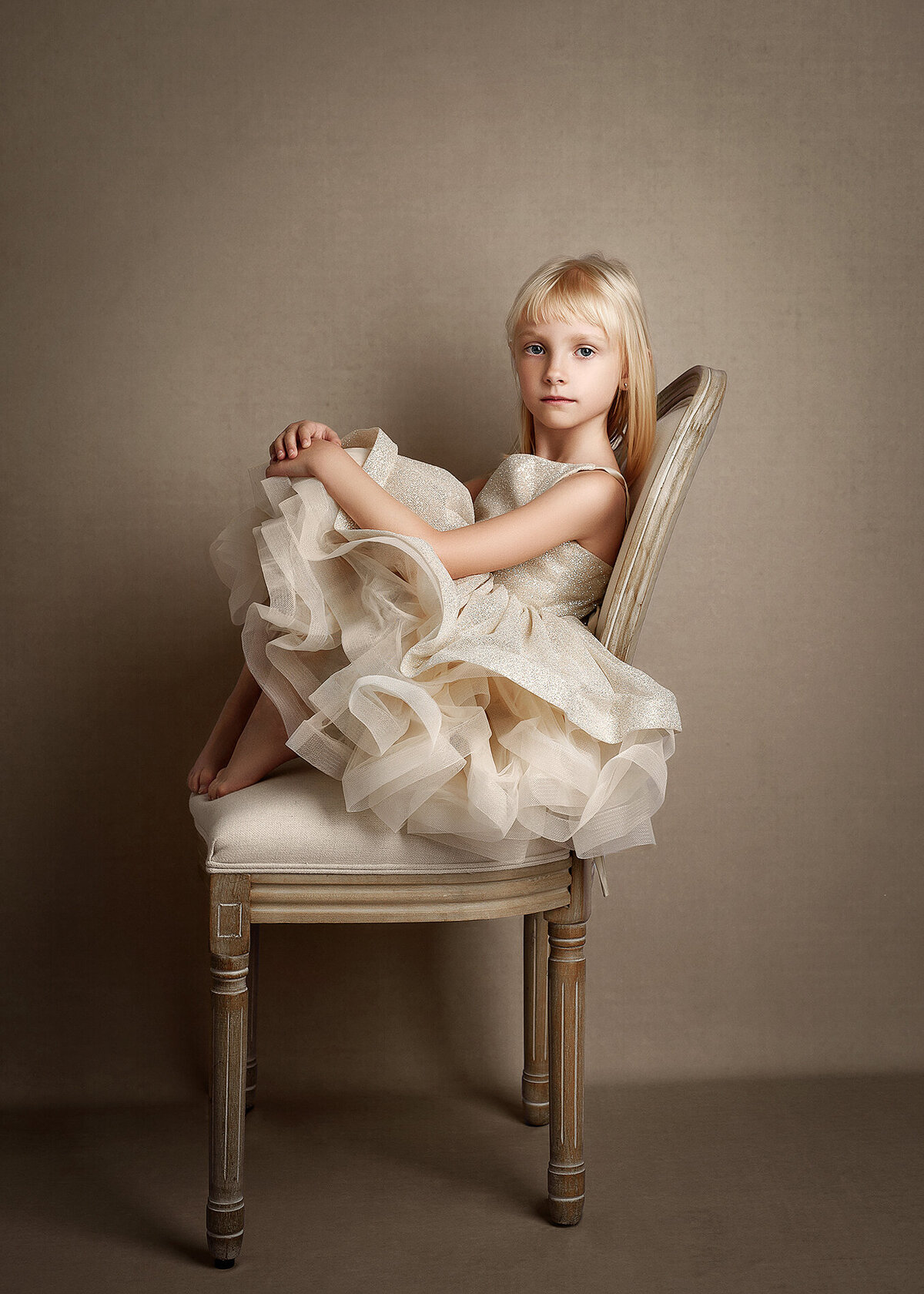 5 year old girl posed sitting on a chair Oswego