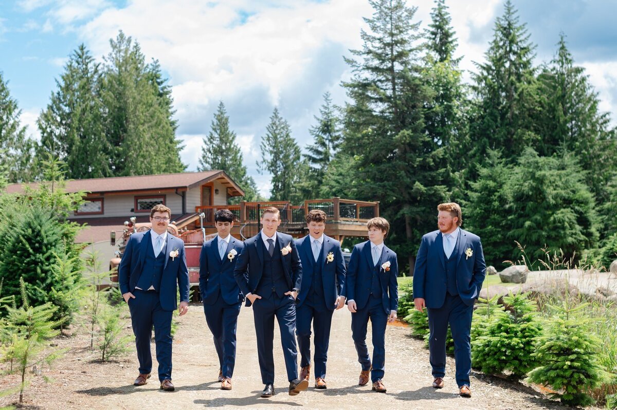 groom and groomsmen walking in tree farm washington wedding venue