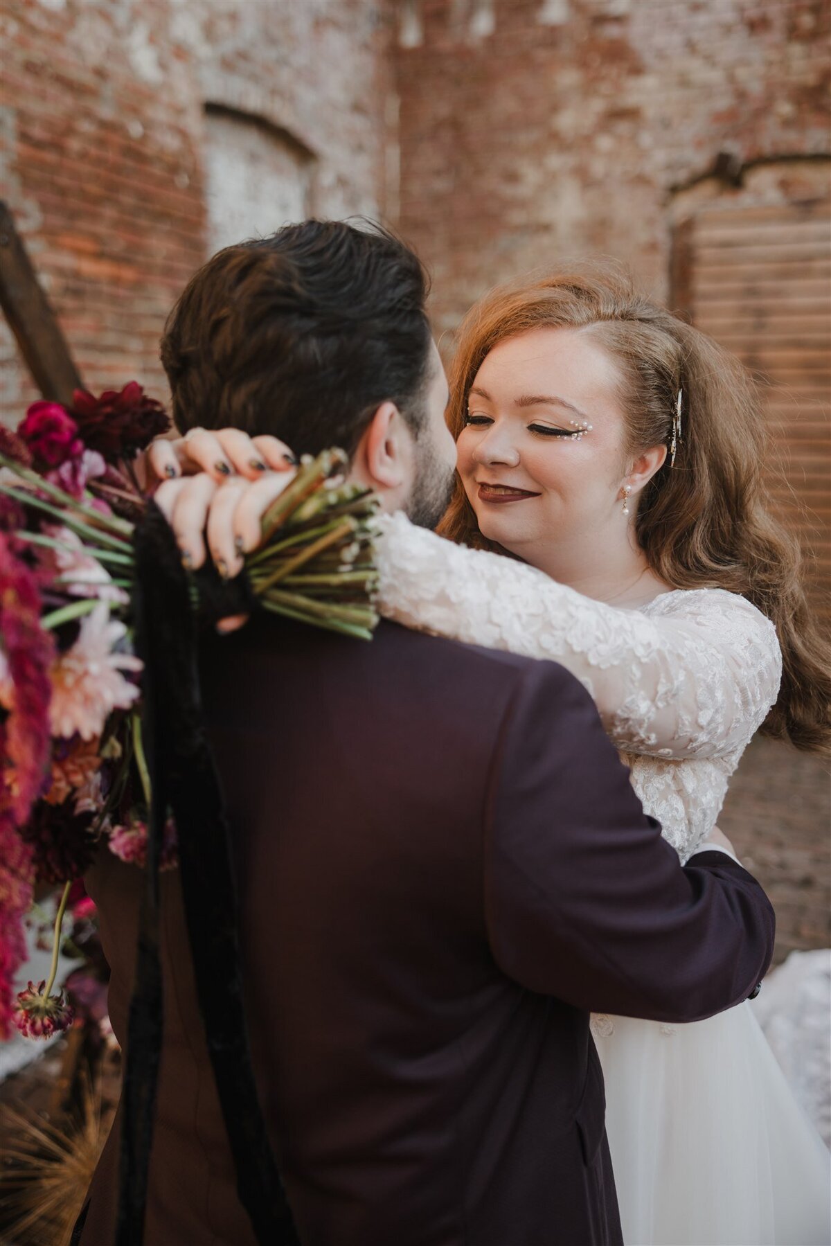 Wedding day portraits of a couple embracing at The White Chapel Projects in New Jersey