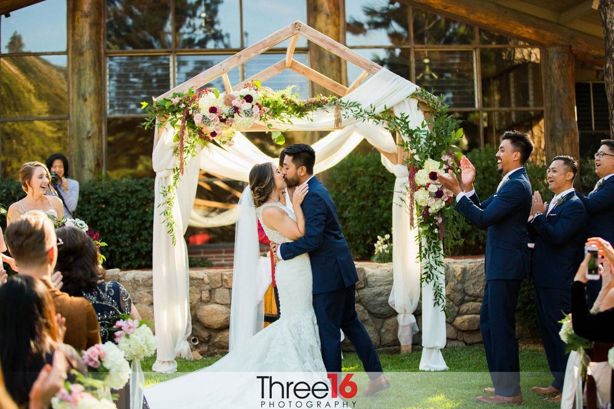 Bride and Groom share their first kiss as Husband and Wife at the altar
