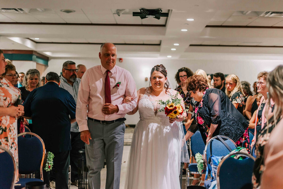 Bride and her dad walking down the aisle.