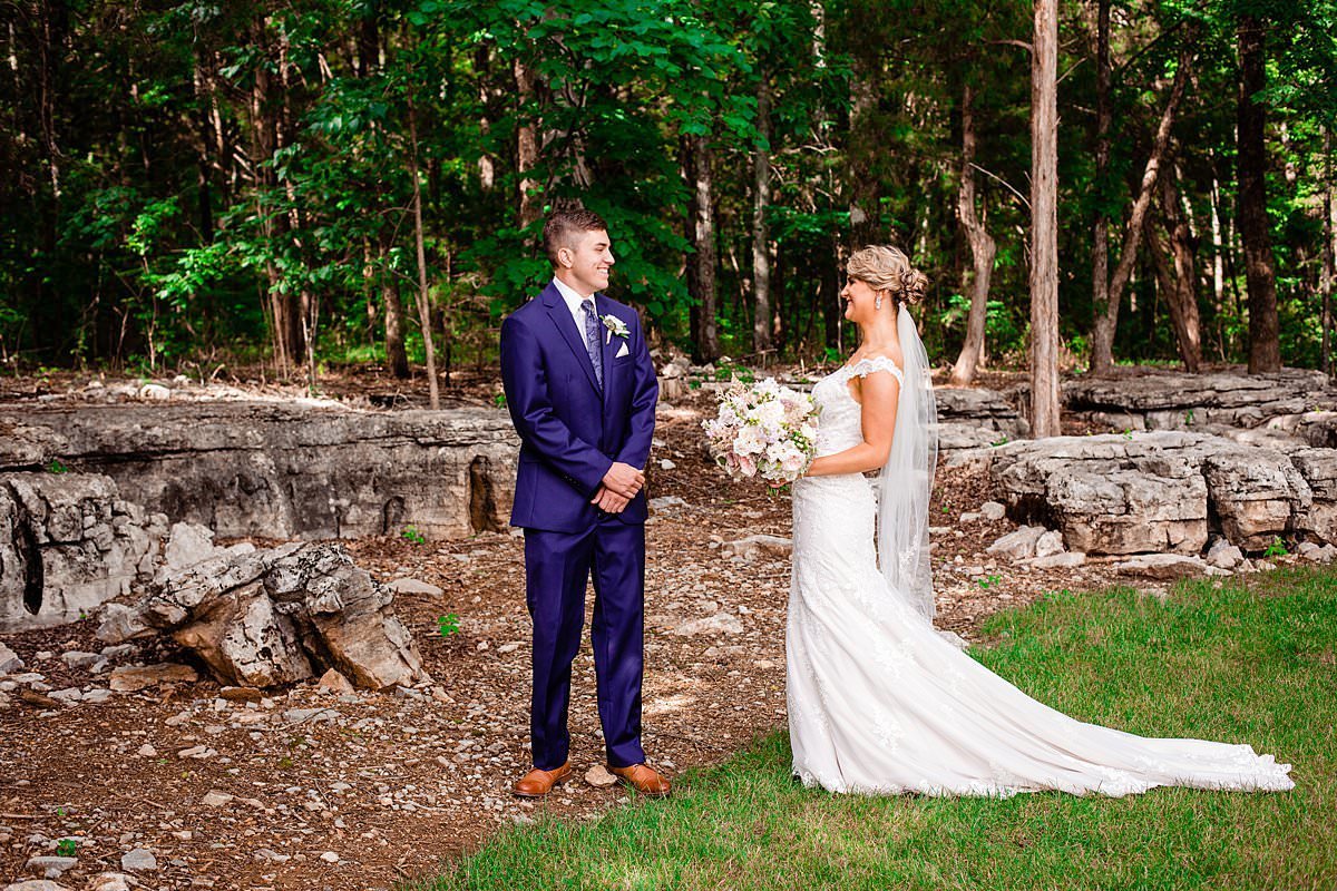 First look with bride and groom near rock wall at Saddlewood Farm