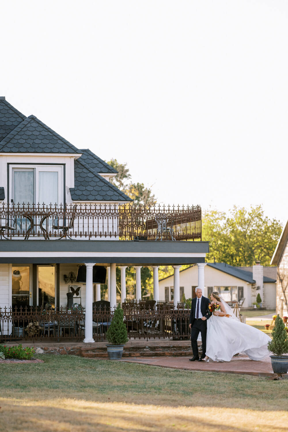 bride-and-dad-walking-in-front-of-house