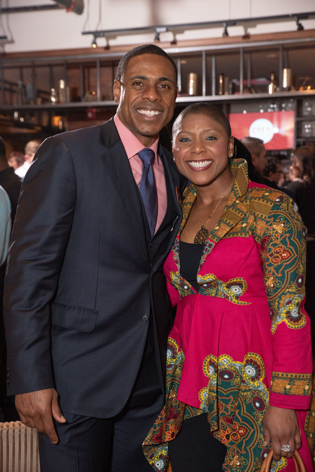 Man and woman happily smiling during their corporate event