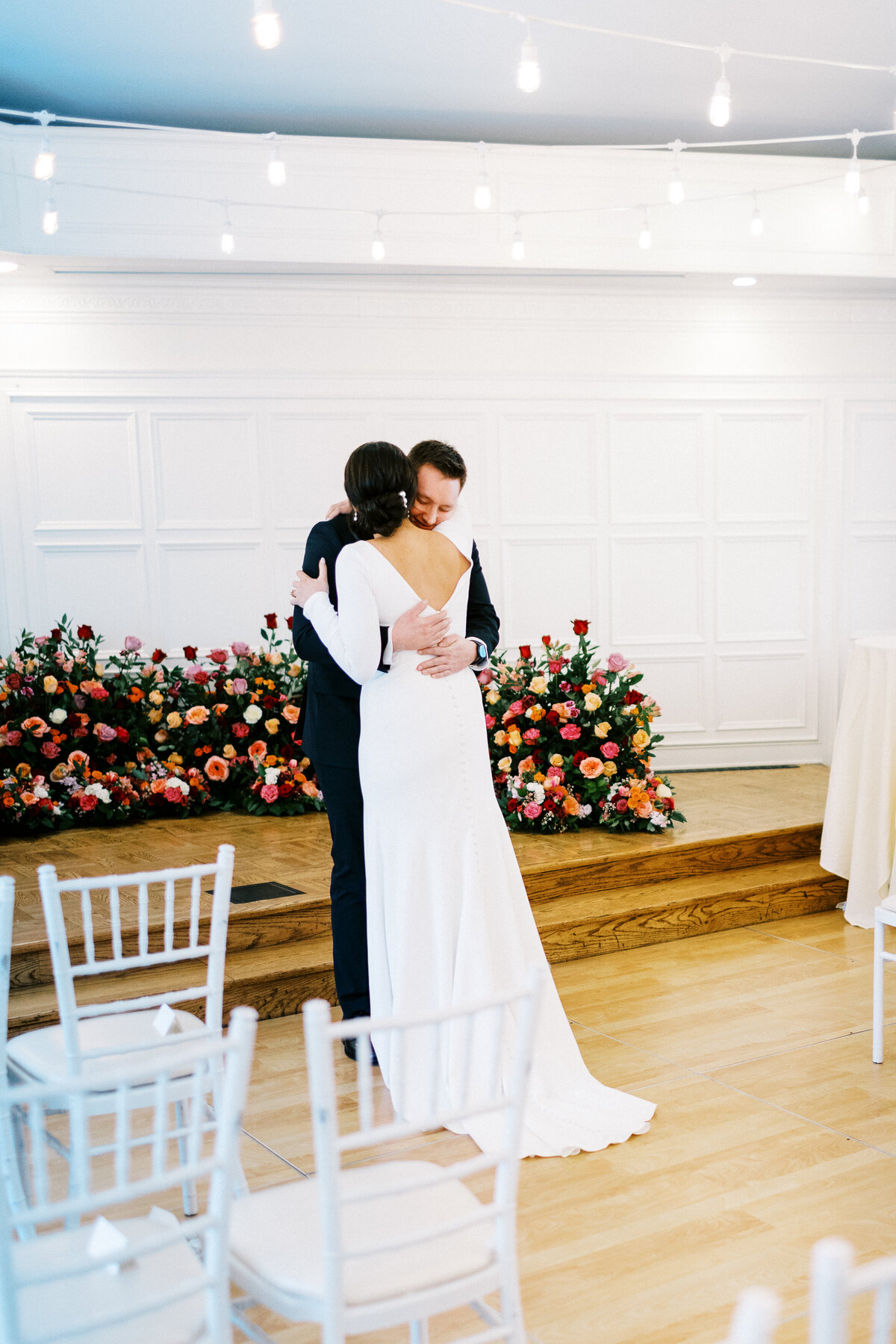 Groom hugs the bride after the first look