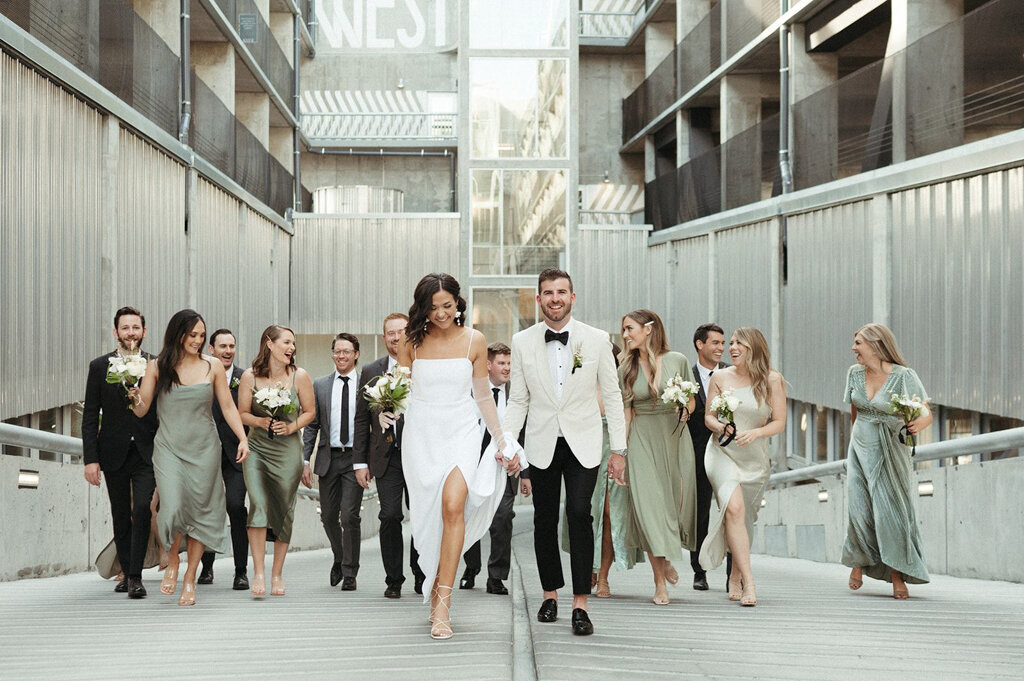 Wedding party walking in downtown Calgary, wedding by Coco & Ash, an intimate and modern wedding planner based in Calgary, Alberta.  Featured on the Brontë Bride Vendor Guide.